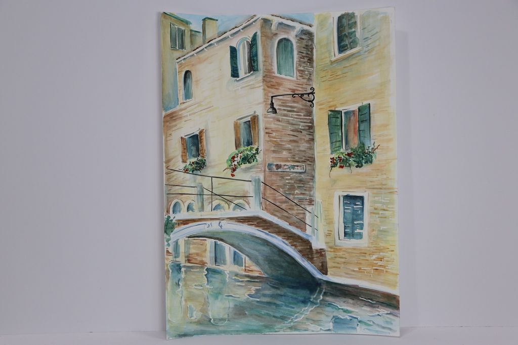 Watercolor painting of a Venice canal and bridge.